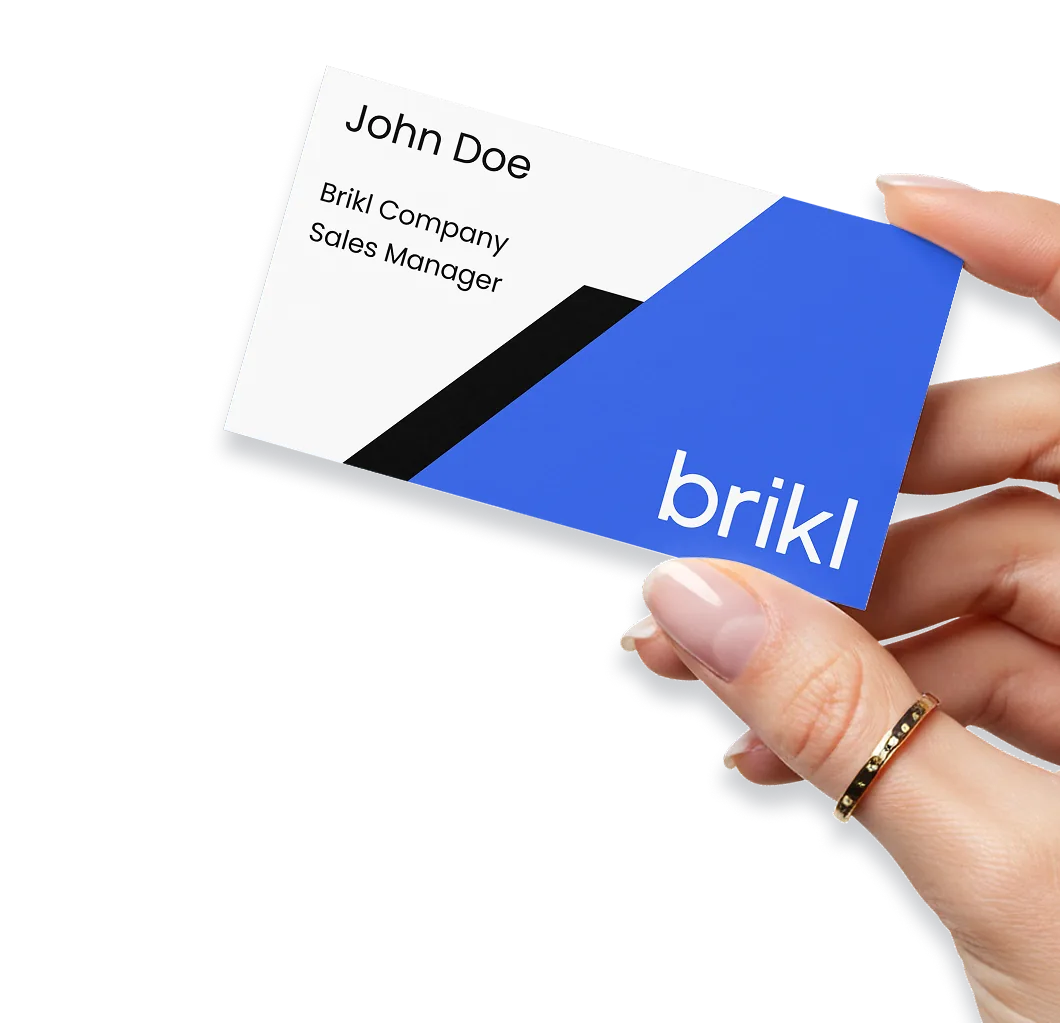 A hand holding a personalized business card, printed on demand by Taylor OnDemand through Brikl